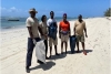 Participants Carry Trash During the Diani Beach Clean- Up Day